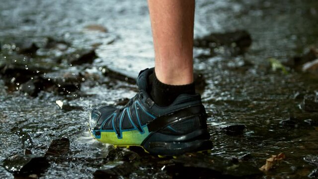 Super slow motion of man foot running in river, splashing around. Filmed on high speed cinema camera, 1000 fps.