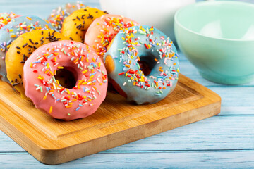 Delicious assorted colorful donuts on the table.