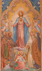 VIENNA, AUSTIRA - JUNI 24, 2021: The fresco of heart Jesus among the saints in the Votivkirche...