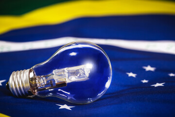 burnt out light bulb over brazil flag texture, concept of brazilian energy crisis