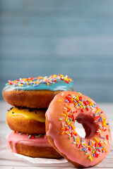 Delicious assorted colorful donuts on the table.
