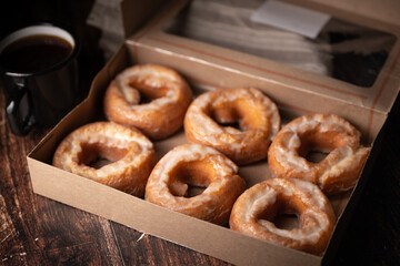glazed old fashioned style doughnut on dark background