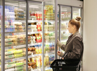 Woman choosing a dairy products at supermarket