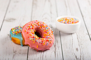 Delicious assorted colorful donuts on the table.