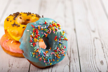 Delicious assorted colorful donuts on the table.