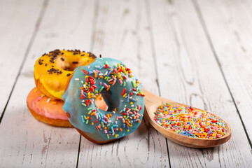 Delicious assorted colorful donuts on the table.