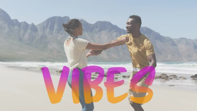 Animation of the word vibes in pink and orange over happy couple dancing on beach
