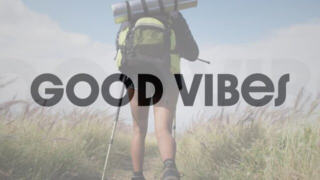 Animation of the words good vibes in black over woman hiking in countryside