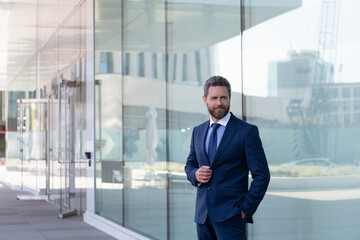 mature bearded man businessman in businesslike formal suit outside the office, business