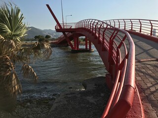 small red bridge located in inciralti urban forest