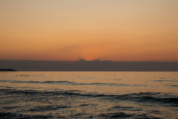 beautiful sunset on the sea. beach and surf at sunset.