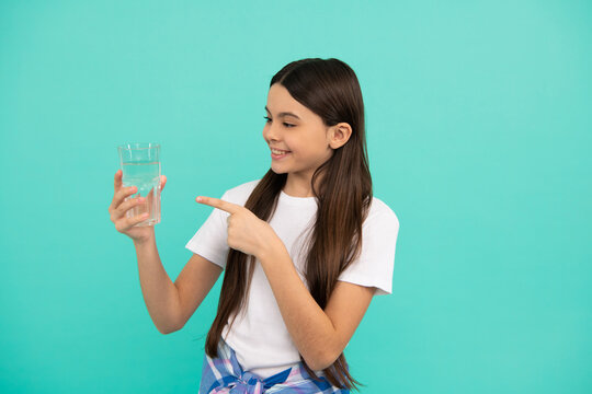 Happy Kid Pointing Finger On Glass Of Water To Keep Daily Water Balance In Body, Hydration.