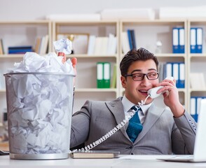 Businessman in paper recycling concept in office