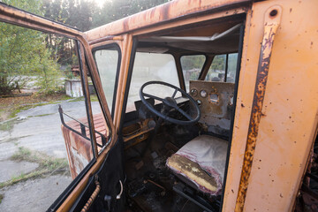 Fototapeta na wymiar Cabin of abandoned radioactive vehicle, old rusty truck near ghost town Pripyat