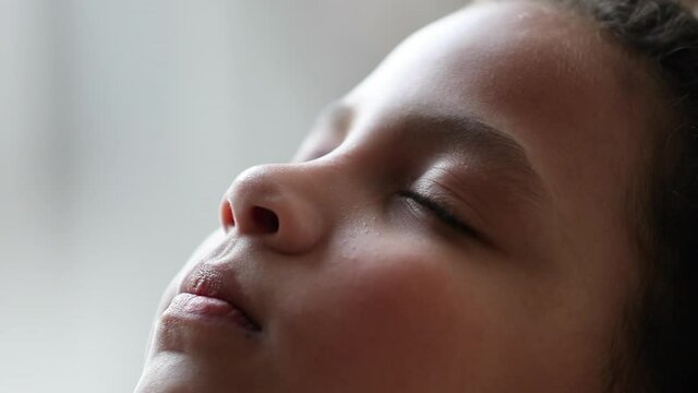 Pretty pensive child eyes closed in meditation