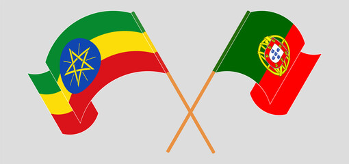 Crossed and waving flags of Ethiopia and Portugal