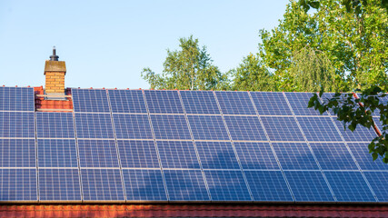 Solar panels completely cover the top of a large house