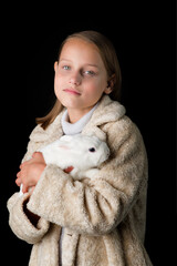 Pretty girl hugging white rabbit