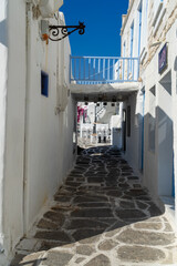 Fototapeta na wymiar Paros, Greece. Traditional whitewashed dotted alley in old city, Cyclades Greek Islands.