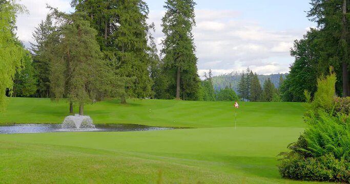 Establishing shot of golf course with gorgeous green and fantastic forest view in Vancouver, Canada, North America. Day time on May 2021. Still camera. ProRes 422 HQ.