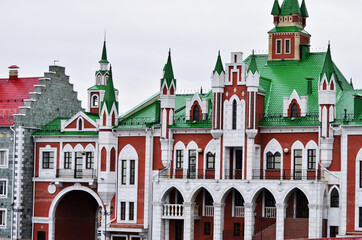 The building of the wedding palace is in the Dutch style of red and white brick with a green roof. Russia Yoshkar-Ola 01.05.2021. High quality photo