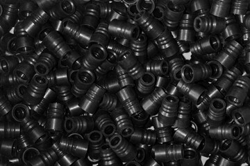 Lots of plastic black fittings for connecting water pipes or plastic pipes. Background, texture....