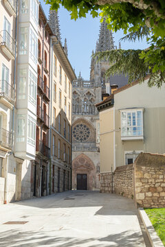 BURGOS, SPAIN - June 29, 2021: view of the main door of Santa Maria de la Catedral de Burgos seen from an alley in the city