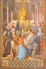VIENNA, AUSTIRA - JUNI 24, 2021: The symbolic fresco of Jesus as the priest with the eucharist in...