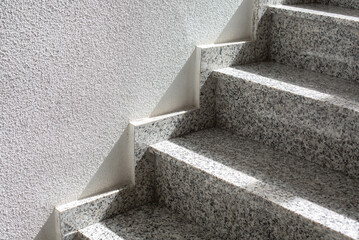 Fragment of a gray granite staircase in the building.