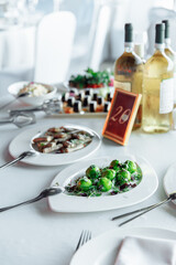 Table setting for a banquet or celebration. Empty wine glasses for spirits, champagne and juice. Set the table. Cloth napkins on a platter. Banqueting hall. Cold appetizers and salads.