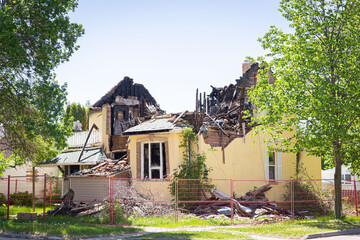 burned stucco home with the roof burned and caved in