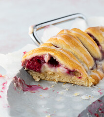 Close up view of a portion of a raspberry crescent ring taken from the side of it.