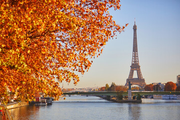 Scenic view of the Eiffel tower over the river Seine from Mirabeau bridge on a bright fall day in...