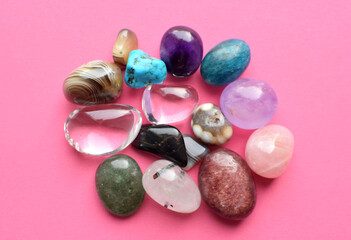Tumbled and rough gemstones and crystals of various colors. Amethyst, rose quartz, agate, apatite,...