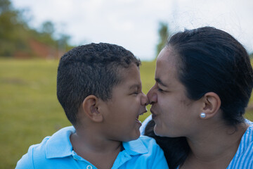 Fototapeta premium Latino Boy Playing With His Latina Mom's Nose