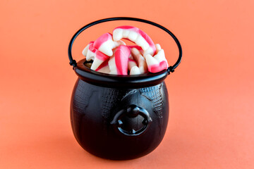 Happy Halloween decoration on orange background. Halloween Cauldron.