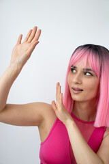 Portrait of girl with pink hair in pink sport top.