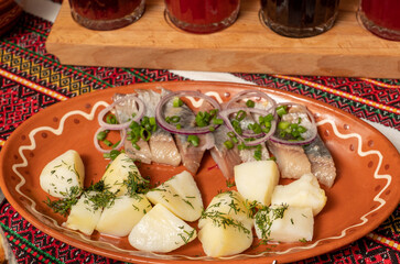 traditional plate with salted herring and boiled potatoes