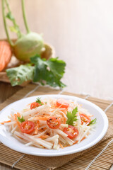 Salad with sliced kohlrabi, carrot, tomato and mizuna leaf on white dish, Vegan food, Healthy eating