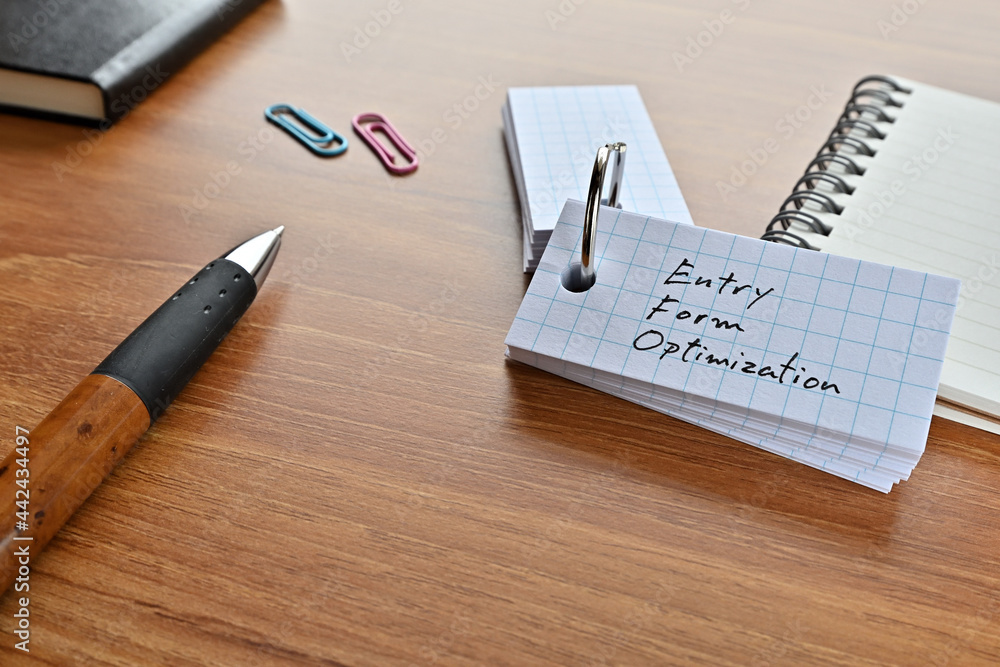 Aufkleber there is a word book with the word entry form optimization written on it with a pen and paper clips.