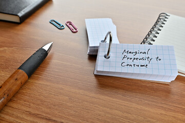 There is a word book with the word marginal propensity to consume written on it with a pen and...