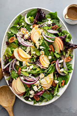 Winter salad with apple and pecans with vinaigrette dressing