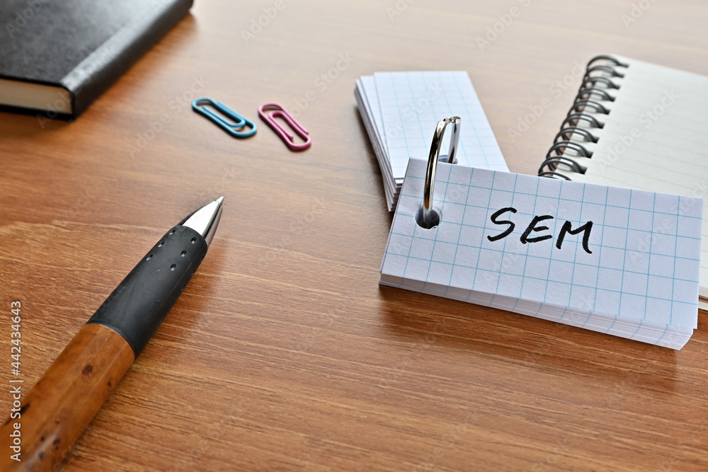 Poster there is a word book with the word of sem which is an abbreviation for search engine marketing on th