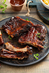 Grilled barbeque ribs with BBQ sauce and sides