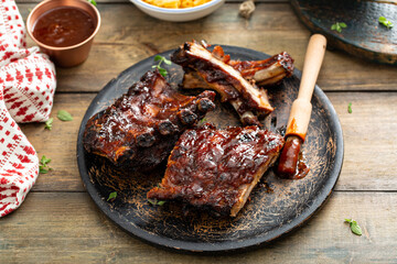 Grilled barbeque ribs with BBQ sauce and sides