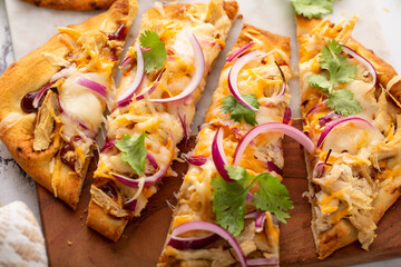 Barbeque chicken flatbread with cheese and red onion