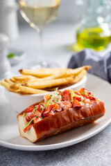 Lobster roll served with fries and white wine