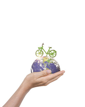Hand holding globe earth with green bicycle isolated on white background. Elements of this image furnished by NASA