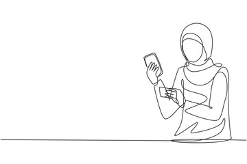 Continuous one line drawing young Arabian woman typing entering credit card code on smartphone around desk. Digital lifestyle and payment concept. Single line draw design vector graphic illustration