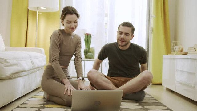 Two friends are starting to watch something on the computer 